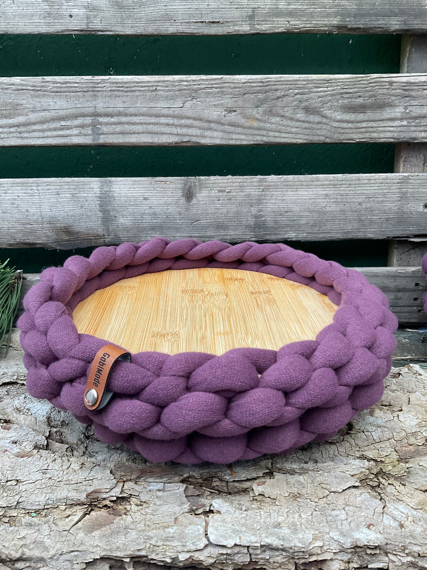 Ein gestricktes Tablett mit Holzteller