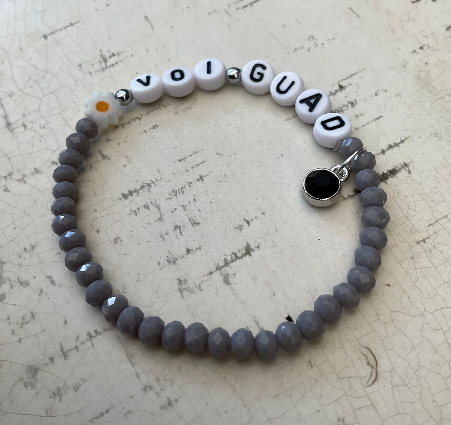 Ein graues perlenarmband Voi guad mit Anhänger 