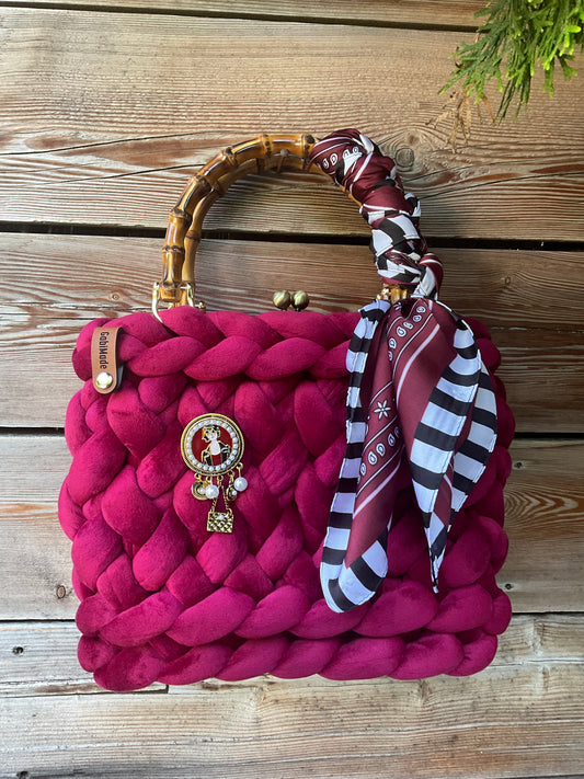 Eine Bordeaux Trachtentasche mit Brosche und Tuch