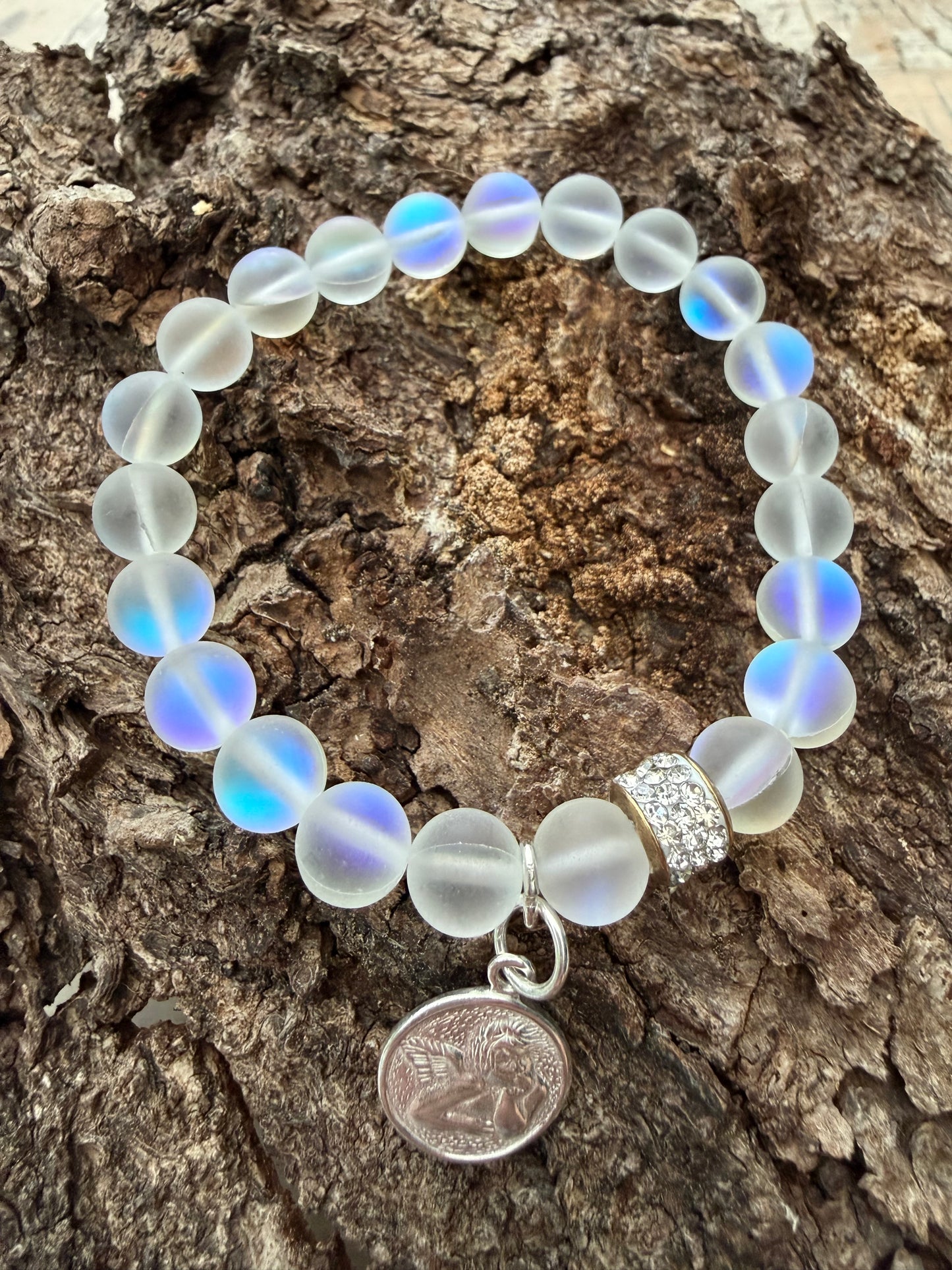 Ein schimmerndes Perlenarmband mit Schutzengel Anhänger 