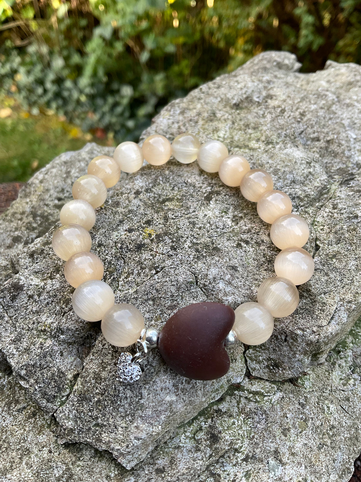 Ein Perlenarmband mit Herz und Herzanhänger 