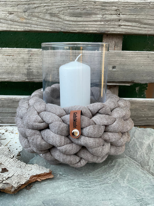 Ein gestricktes Taupe farbenens Windlicht mit Glaseinsatz und Kerze 