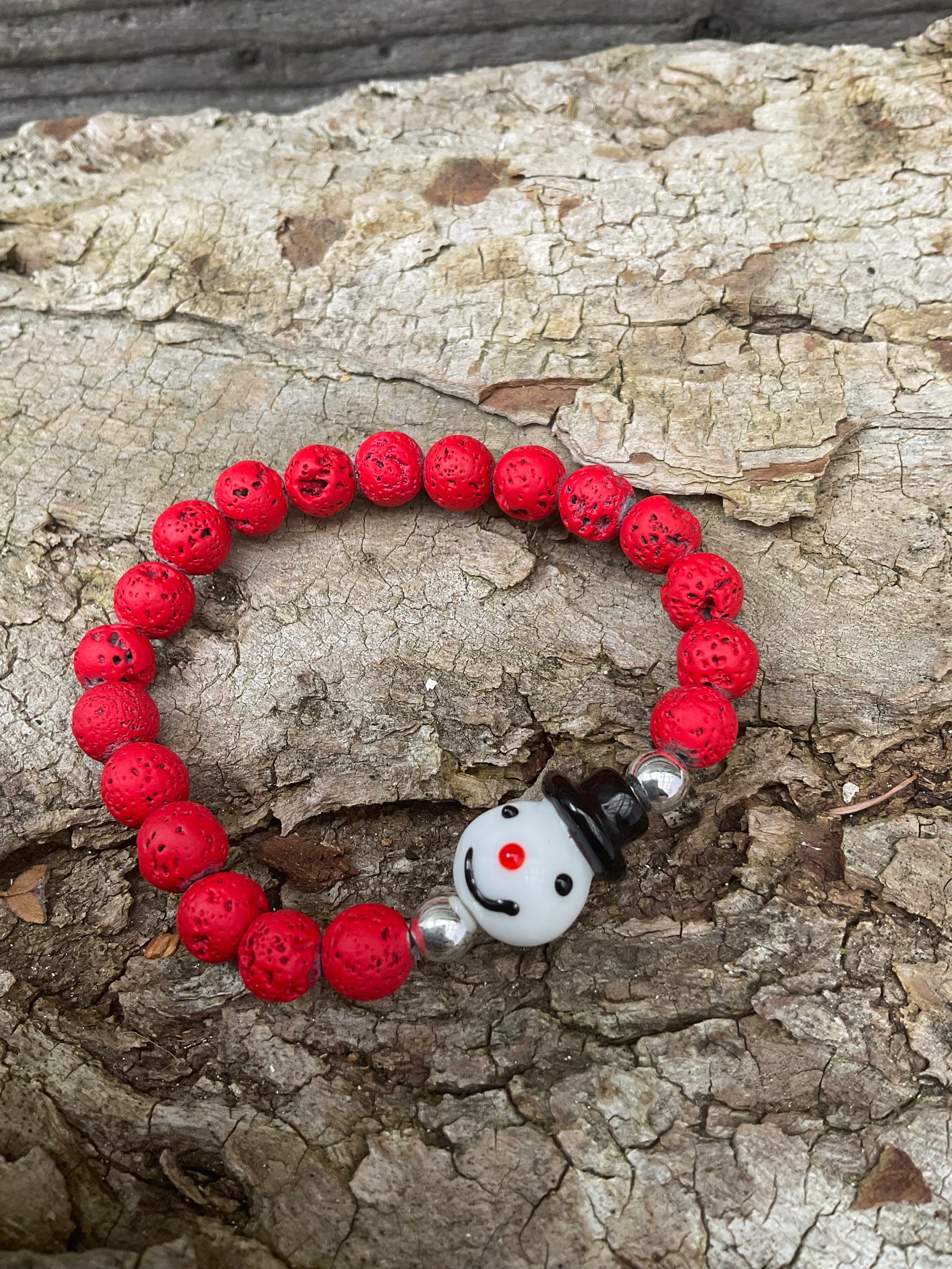 Ein rotes Perlenarmband mit Schneemann Perle 