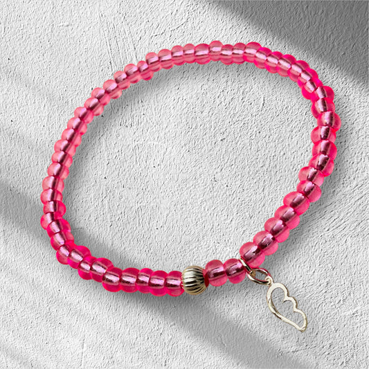 Ein pinkes Perlenarmband mit Silberperle und Flügelanhänger 