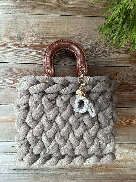 Eine gestrickte hellbraune Tasche mit Henkel 