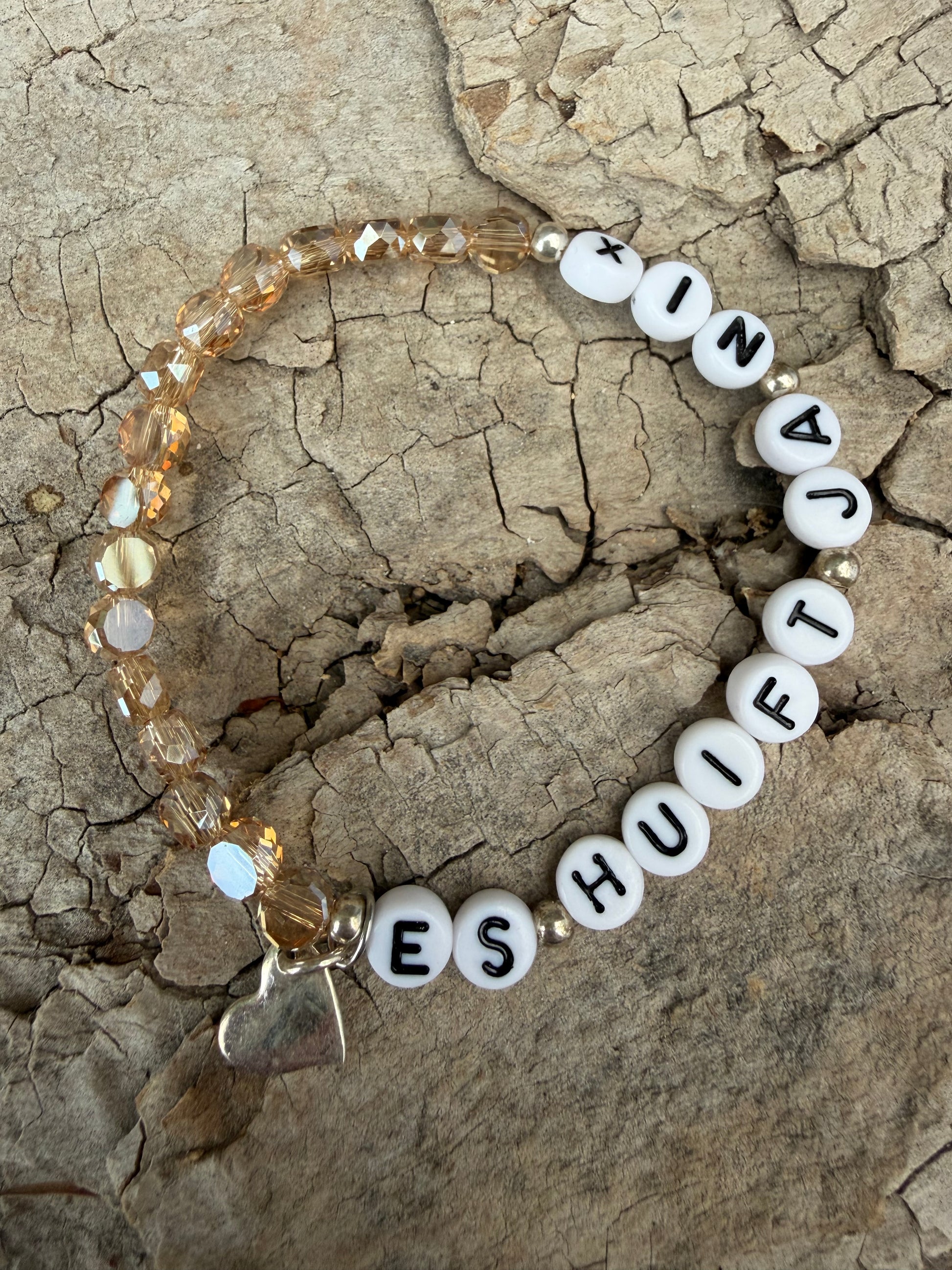 Ein Armband in Champagner mit herzanhänger
