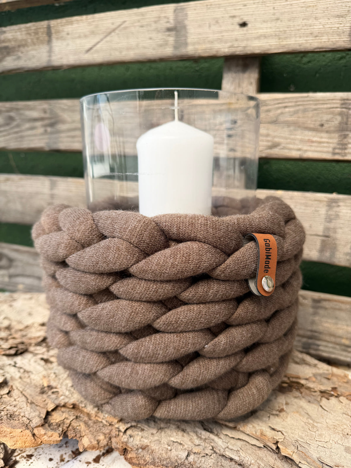 Ein gestricktes braunes Windlicht mit glaseinsatz 